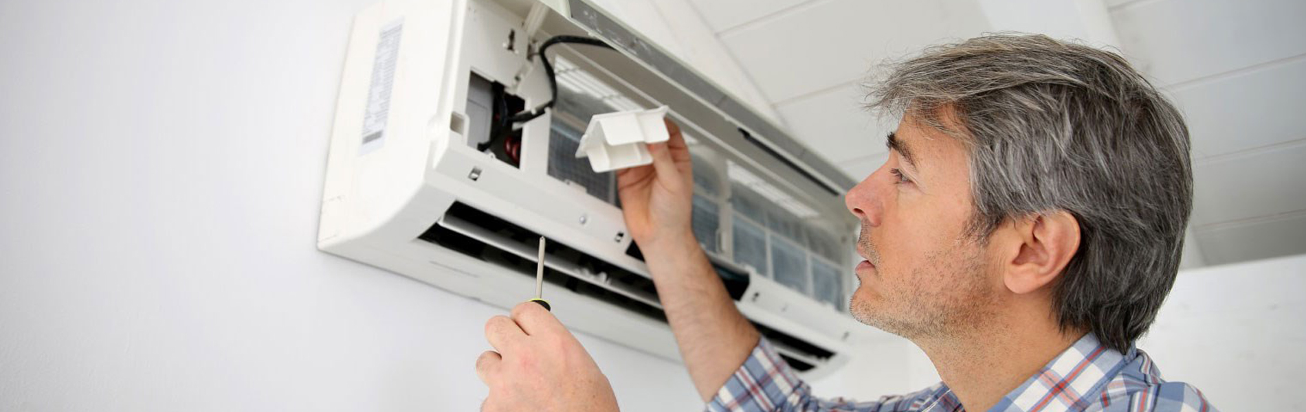 Aircond repair technician at work